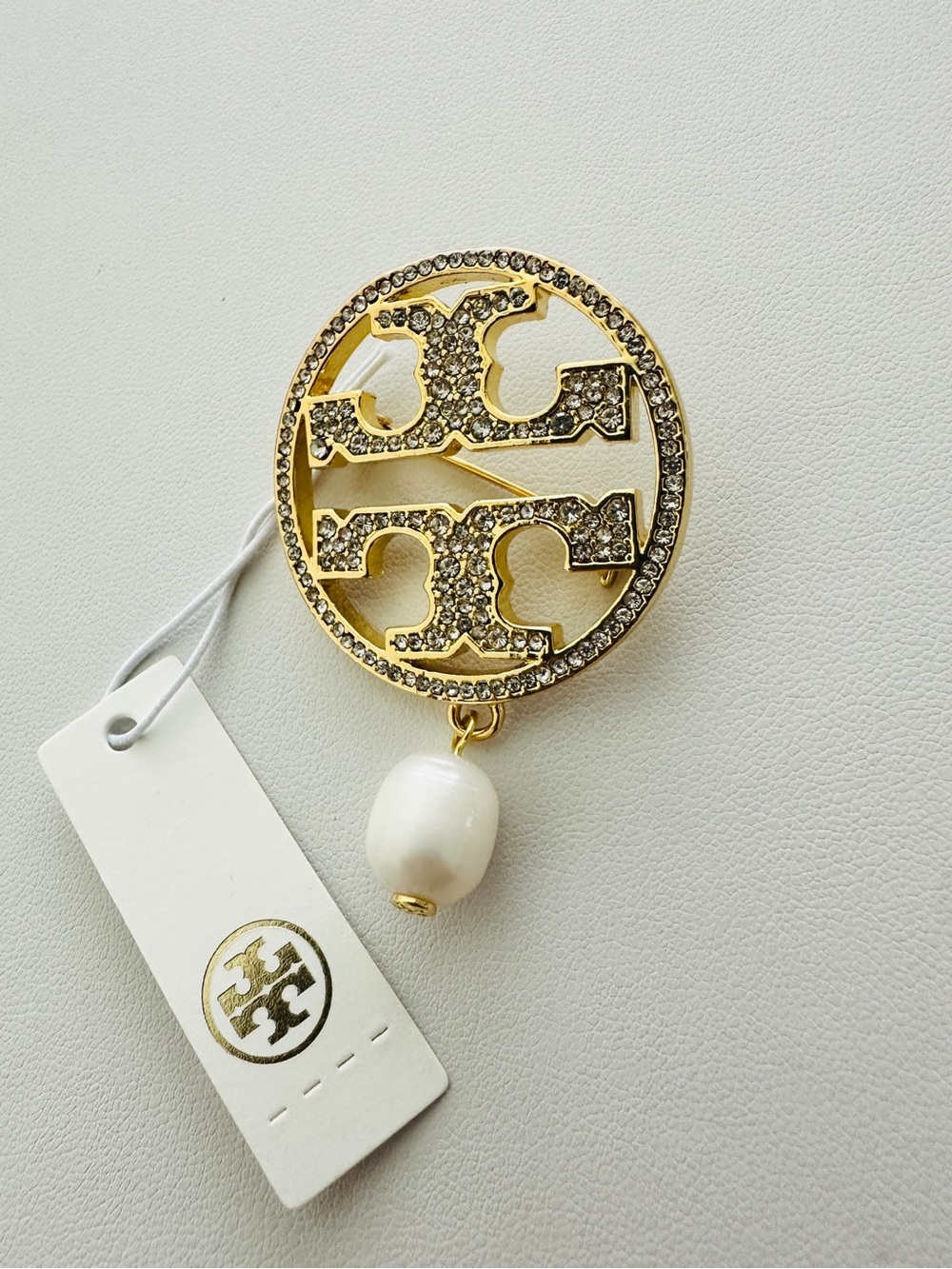 Tory Burch Gold-Tone Crystal Logo Brooch with White Pearl Drop